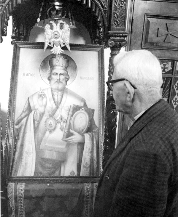 Old man examining painting of a weeping icon at Greek Orthodox Church - Tarpon Springs, Florida