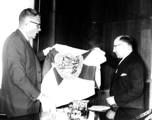 Secretary of State Tom Adams (left) presenting Florida State Flag to Dr. Fernando Gomez-Martinez - Bogotá, Colombia