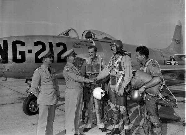 National Guard pilots and officers shaking hands in front of a military plane - Jacksonville, Florida.