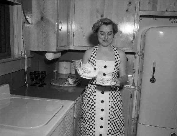 Unidentified woman pouring a cup of tea - Jacksonville, Florida.