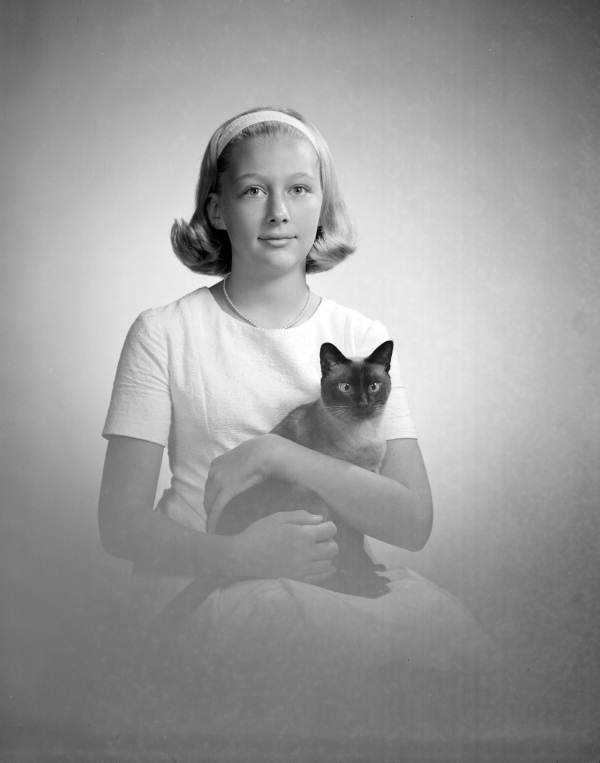 Portrait of Kim Mathews holding a Siamese cat - Tallahassee, Florida.