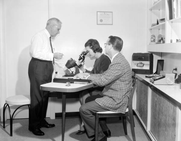 Lester Moon of Moon's Jewelers store assisting a couple with the selection of a gem - Tallahassee, Florida.