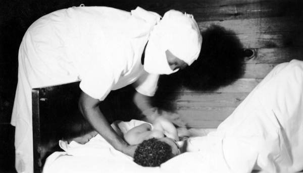 Midwife with a newborn infant.