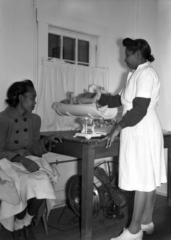 Public health nurse weighing a baby in Miami, Florida.