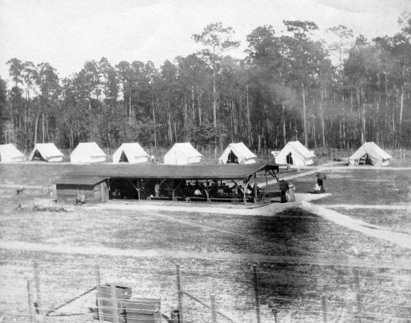 View showing people gathered at a pavilion in a quarantined isolation camp.