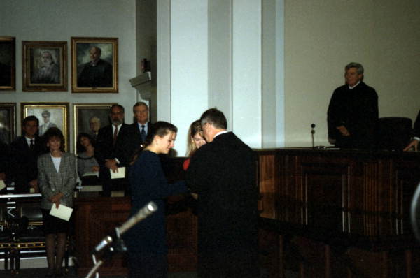 Scene showing newly sworn-in Justice Harry Lee Anstead (center) getting help from his daughters during the enrobing ceremony in Tallahassee, Florida