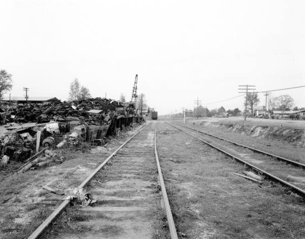 Looking north at Hannon Lumber Company with Woodville Highway and El Camino Motel in the distance