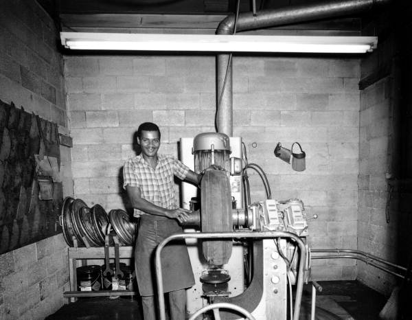 Unidentified employee repairing a tire - Tallahassee, Florida .