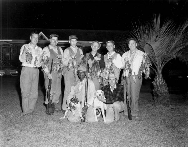 Unidentified quail hunter gather after hunting