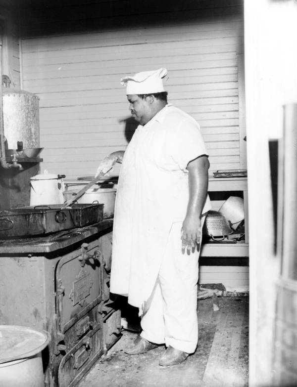 Camp cook preparing a meal - Wakulla County, Florida.