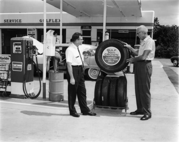 Two men with tires at David Green's Gulf Service Station - Tallahassee, Florida .