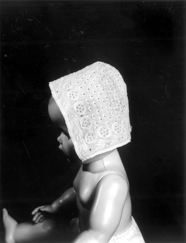 Antique handmade baby bonnet on a model