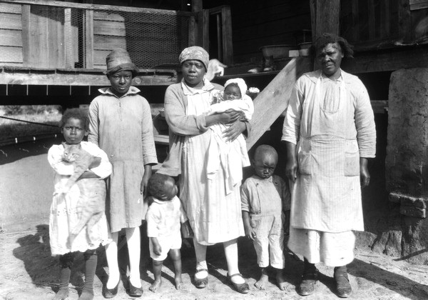 Family standing in front of their house