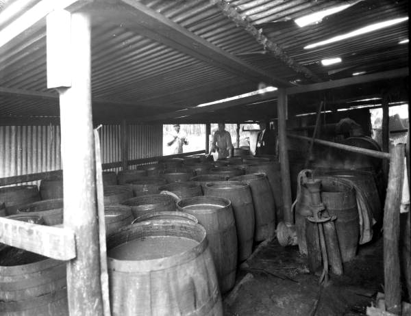 Sheriff W.B. Cahoon (right) and barrels of moonshine confiscated from a Jacksonville still.