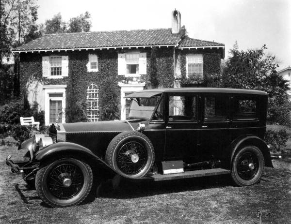 Rolls Royce in front of a house.