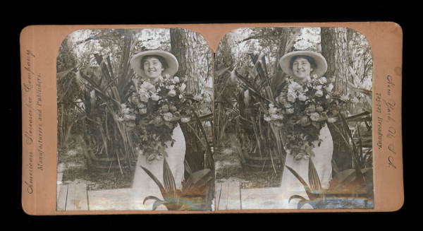 Woman hugging large bouquet of flowers
