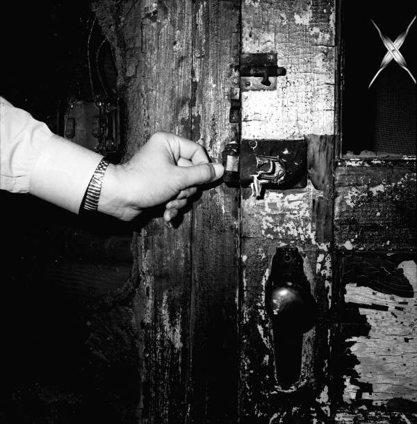 Close-up view showing locks at the home of Tom Hadley after a fire - Tallahassee, Florida.