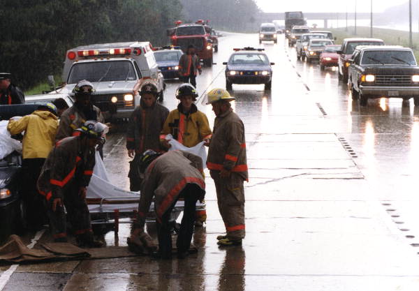 View showing TFD firefighters standing around gurney on I-10 in Tallahassee, Florida.