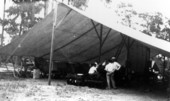 Tractors under a tent during Farmers Week - early Extension work