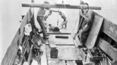 Men retrieving cannon from shipwreck