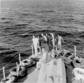 Treasure hunters assembled at the bow of a boat for portrait