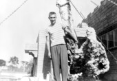 Art McKee's son, Wayne, posing near the entrance to his father's museum - Plantation Key, Florida