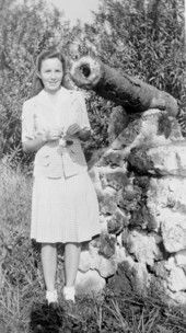 Art McKee's wife, Gay, standing next to a cannon retrieved from a shipwreck