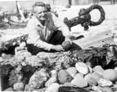 Art McKee posing with ballast on mock shipwreck display - Plantation Key, Florida