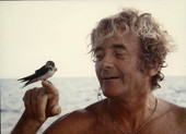 Jack Haskins with small bird during Genovesa shipwreck treasure hunt at Pedro Bank, Jamaica