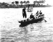Swimmers in a rowboat