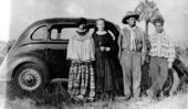 Deaconess Bedell and Mikasuki Indians standing by a car