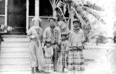 Deaconess Bedell and the Buster family, outside the Glade Cross Mission - Everglades City, Florida