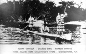 Seminole men in a dugout canoe - Chokoloskee, Florida