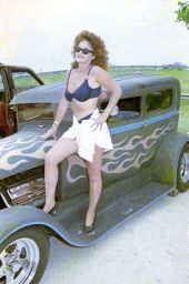 Beauty contestant posing on a hot rod during the Battle of the Bands festival in Okeechobee.