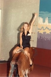 Woman riding a mechanical bull.