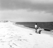 Two men look out on the water.