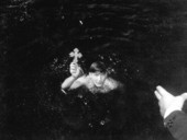 Navy veteran Mike Koulianos retrieves the second cross during Tarpon Springs' Epiphany celebration - Tarpon Springs, Florida