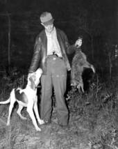Jimmie Reed rewards his dog as he displays the trophy - Homosassa Springs, Florida