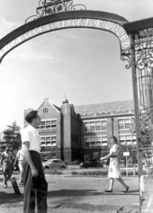 Students walking near iron archway at Florida State College for Women - Tallahassee, Florida.