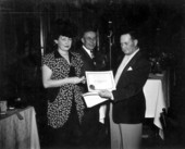 Mrs. Frank Winchell receives her $150 certificate for winning first place in a fishing tournament - Jacksonville, Florida