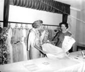 Women looking over dresses at a fashion council