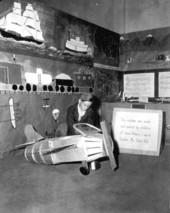 Jack Graham standing by model plane at State Fair - Tampa, Florida