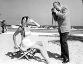 Photographer Dean Cornwell photographs Mrs. Hjordis Termesden on the beach - Palm Beach, Florida.
