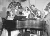 Group around piano during water pageant at Lake Hollingsworth in Lakeland.