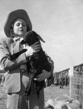 A young woman holding 1-month-old Karakul lamb Zaza - Irvine, Florida