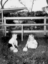 5 year old Michael Powell and 4 year old Linda Mae Powell holding ostrich eggs - Saint Augustine, Florida