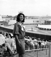 Miss Florida 1965, Carol Blum, on spectator stands at the New York World's Fair.