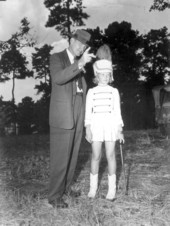 Governor Millard Caldwell speaks to a young drum majorette - Chattahoochee, Florida