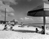 People lying on the sands at South Beach overlooking the Atlantic Ocean - Key West, Florida.