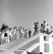 Newsreel cameramen photographing beauty contestants on pool steps at the North Shore Hotel - Miami Beach, Florida